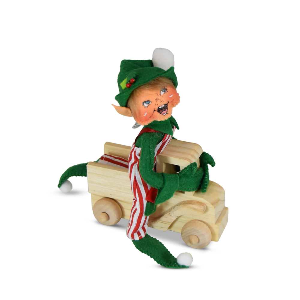 green christmas elf riding toy truck